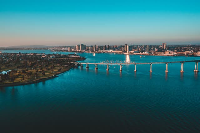 Helicopter shot of the Coronado Bridge with Downtown San Diego in the Background during Sunset | Photo – 4