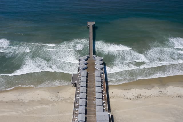 Aerial view of the beach, the surf and the pier in Pacific Beach.