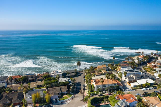 Aerial view of a residential street, the surf and palm trees at Bird Rock.