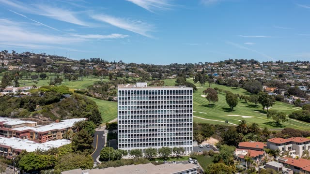 Aerial view of a residential street, palm trees and homes at La Jolla Country Club.