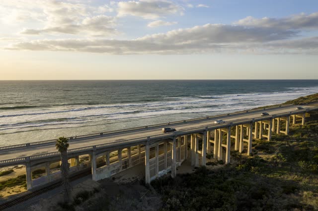 Aerial view of the cliffs, the surf and the bridge in Del Mar.