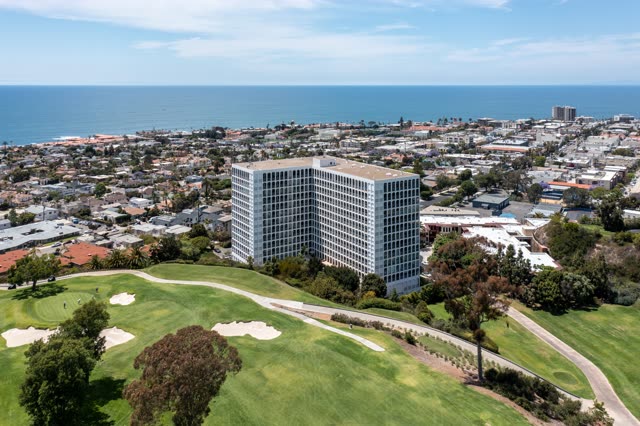 Aerial view of a residential street, the ocean and homes at La Jolla Country Club.