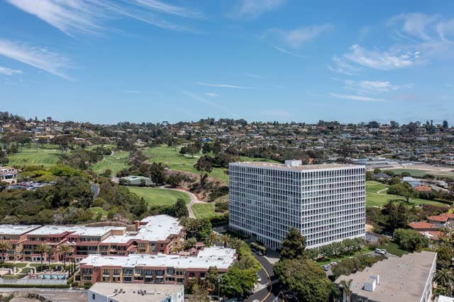 Aerial view of a residential street, palm trees and homes at La Jolla Country Club.