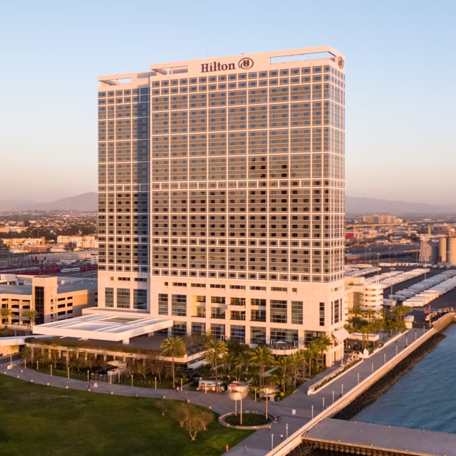 Low aerial view of the downtown streets, palm trees and the bay at Embarcadero.
