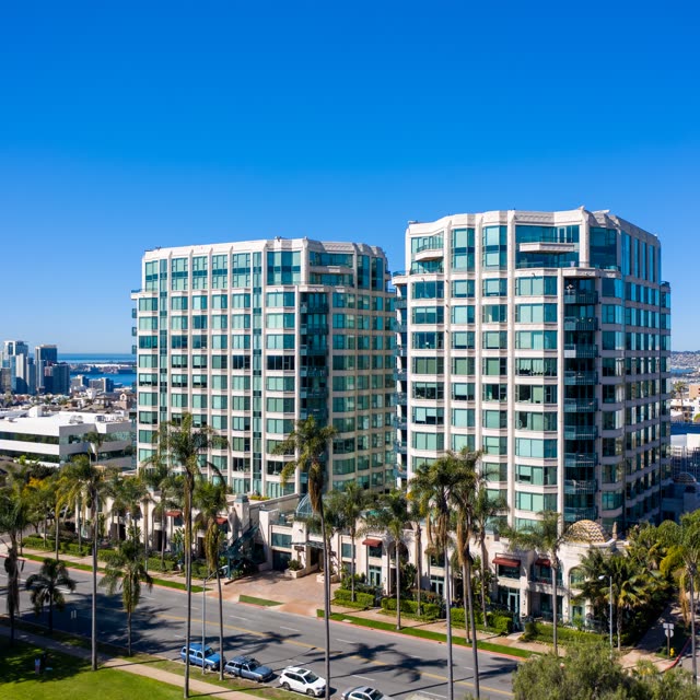 Low aerial view of the downtown streets, the skyline and palm trees at Bankers Hill.