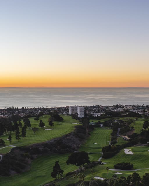 Aerial view of the country inland, palm trees and the ocean at La Jolla Country Club.