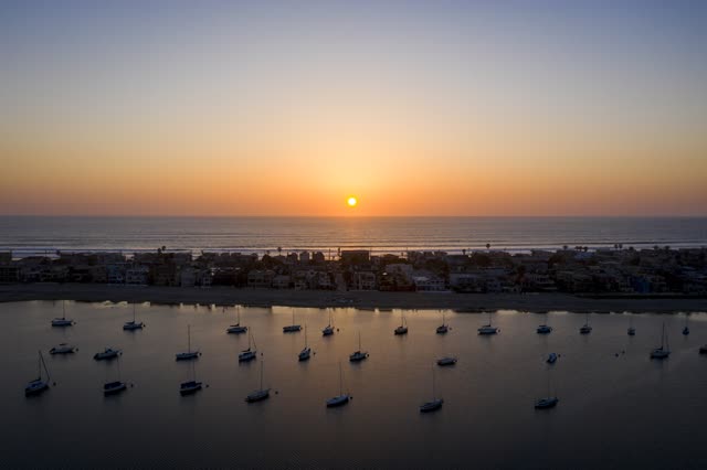 Aerial view of the beach, boats and the ocean in Mission Bay, with boats out.
