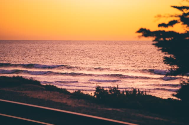 Elevated view of the cliffs, the surf and the ocean in Del Mar.