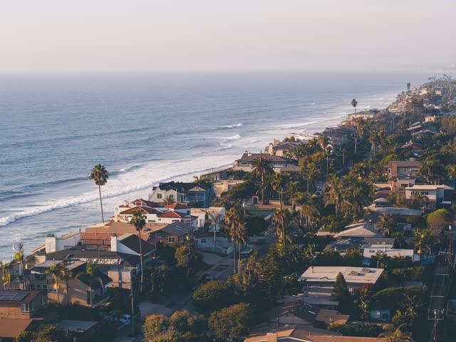 Aerial view of a residential street, the surf and palm trees in Encinitas.