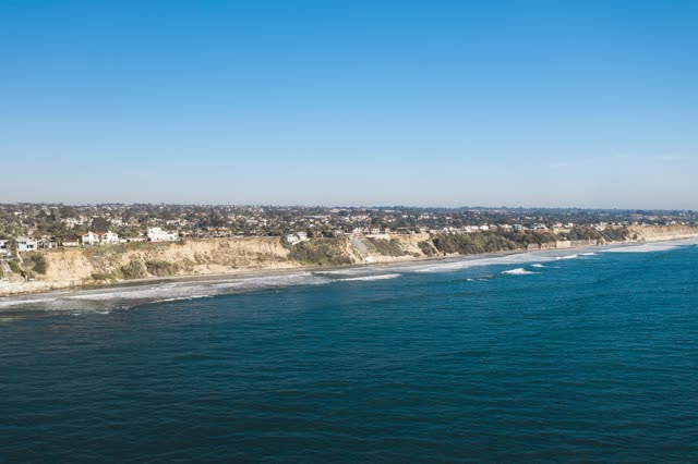 Aerial view of the cliffs, the surf and the ocean in Encinitas.