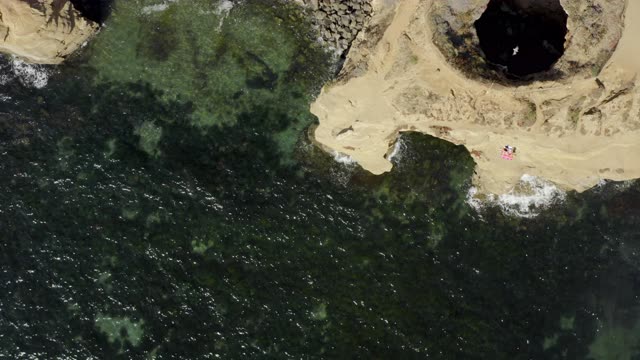 Aerial view of the cliffs, the ocean and the beach at Sunset Cliffs.