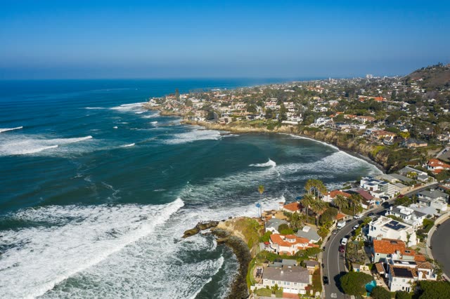 Aerial view of the cliffs, the surf and palm trees at Bird Rock.