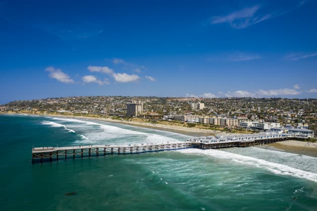 Aerial view of the beach, the surf and the pier in Pacific Beach.