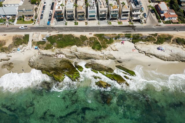 Aerial view of the beach, the surf and palm trees at Windansea.