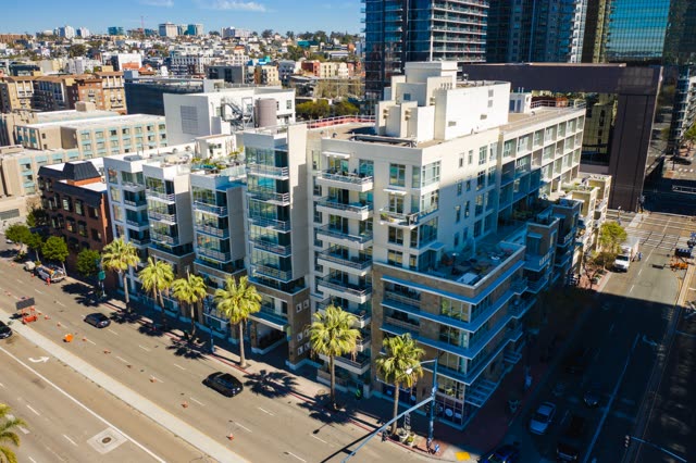 Low aerial view of the downtown streets, the skyline and palm trees at Waterfront.