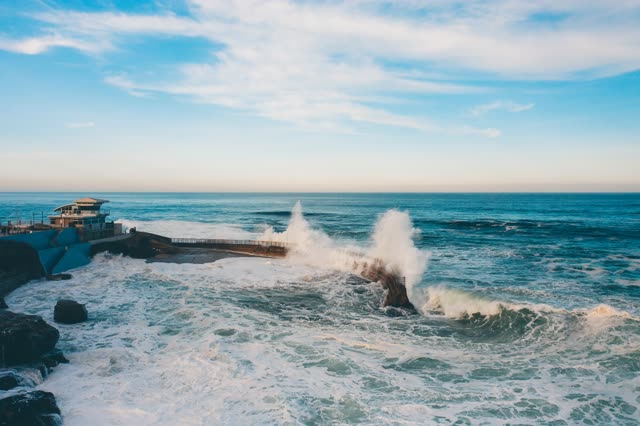 Waves breaking on the seawall at Children’s Pool in La Jolla | Drone Photo – 1