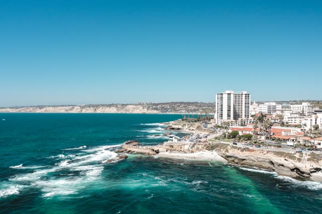 Aerial view of the beach, the surf and the ocean at La Jolla Cove.