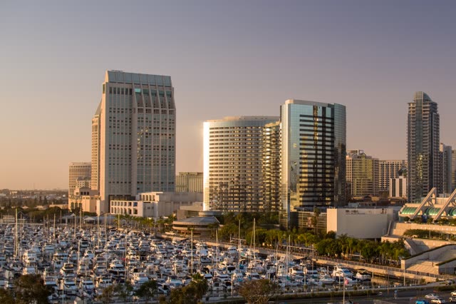 Low aerial view of the downtown streets, the skyline and boats at Embarcadero.