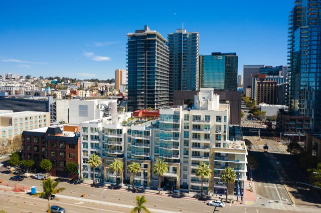 Low aerial view of the downtown streets, the skyline and palm trees at Waterfront.