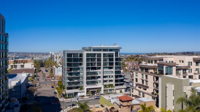 Low aerial view of the downtown streets, palm trees and homes at Bankers Hill.