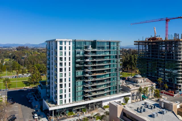 Aerial view of the downtown streets, palm trees and the buildings at Bankers Hill, with a work crew on site.