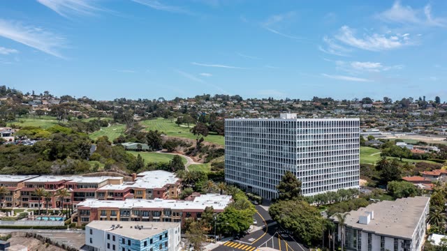 Aerial view of a residential street, palm trees and homes at La Jolla Country Club.