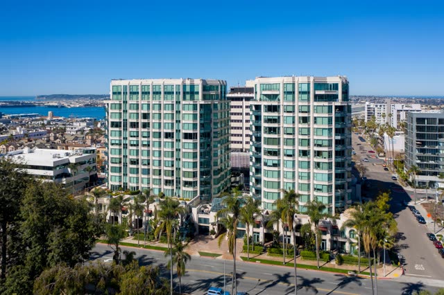 Aerial view of a residential street, palm trees and the bay at Bankers Hill.