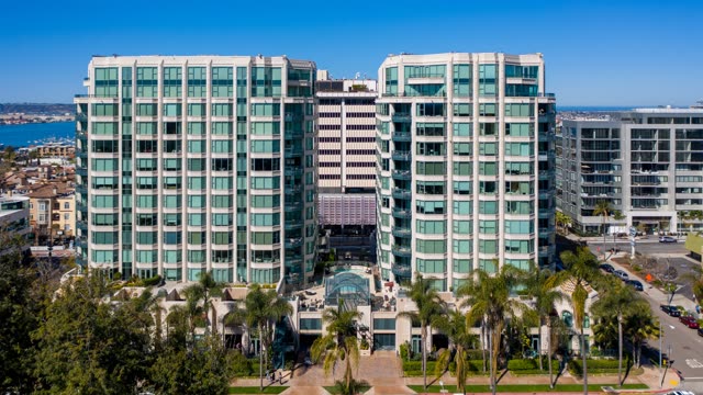 Low aerial view of the downtown streets, palm trees and the bay at Bankers Hill.