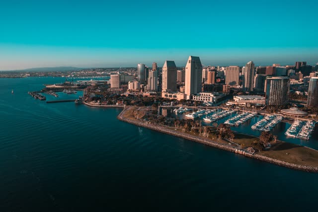 Aerial view of the downtown streets, the skyline and boats at San Diego Marina, with boats out.