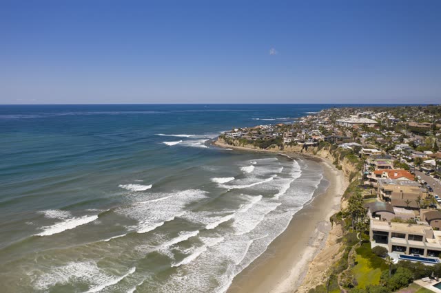 Aerial view of the cliffs, the surf and the ocean in Pacific Beach.