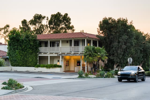 A residential street, palm trees and homes at Covenant.