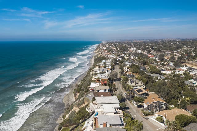 Aerial view of a residential street, the surf and palm trees in Encinitas.