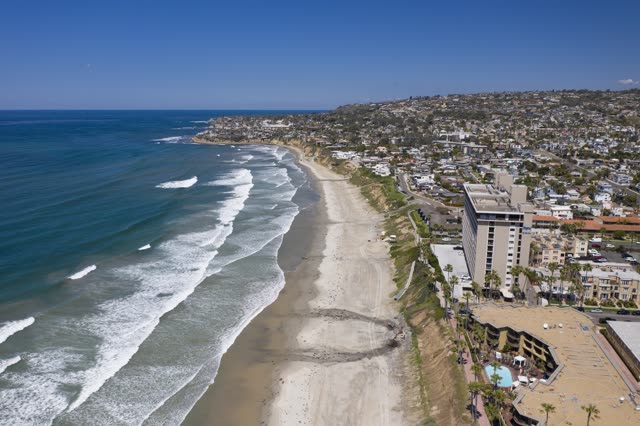 Aerial view of the beach, the surf and palm trees in Pacific Beach.