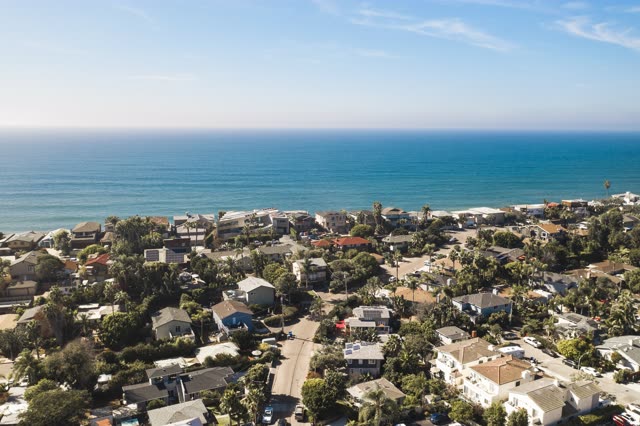 Aerial view of a residential street, palm trees and the ocean in Encinitas.