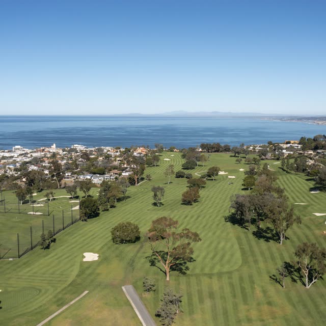 Aerial view of the country inland, the ocean and homes at La Jolla Country Club.