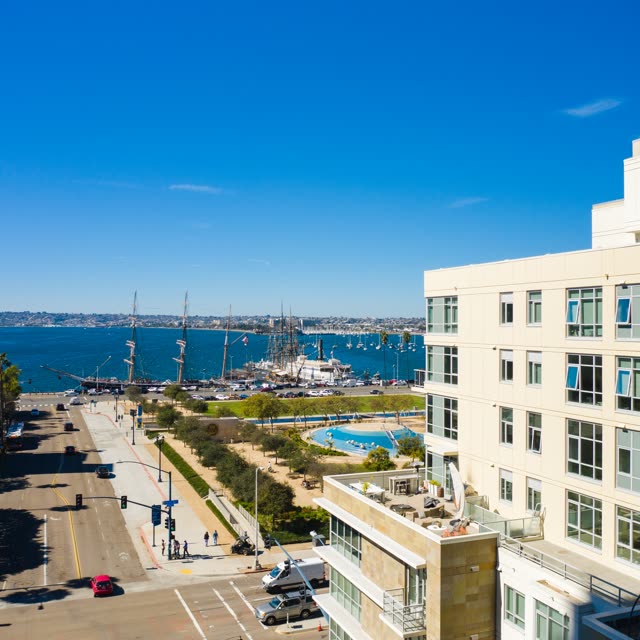 Low aerial view of the downtown streets, boats and the bay at Waterfront, with people walking.