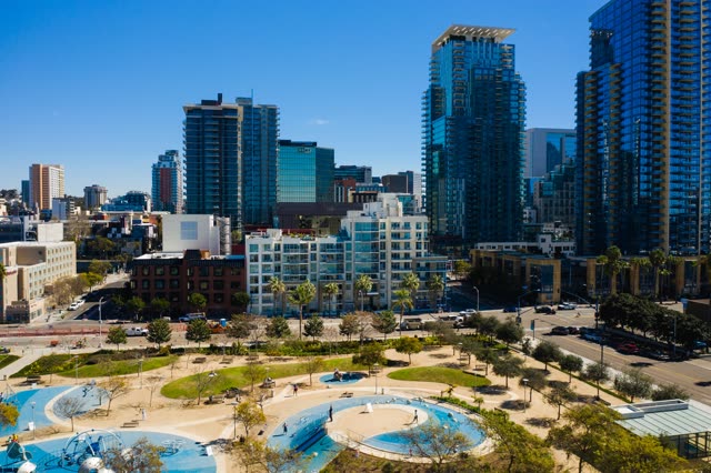 Aerial view of the downtown streets, the skyline and palm trees at Waterfront, with people walking.