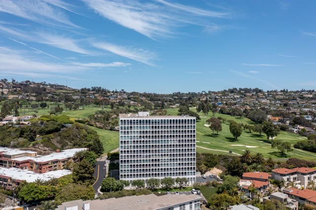 Aerial view of a residential street, palm trees and homes at La Jolla Country Club.