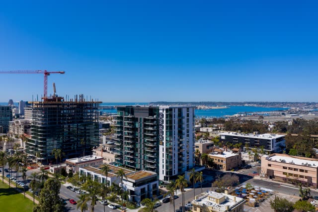Aerial view of the downtown streets, palm trees and the bay at Bankers Hill, with a work crew on site.
