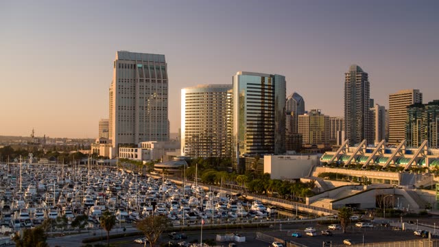 Low aerial view of the downtown streets, the skyline and boats at Embarcadero.