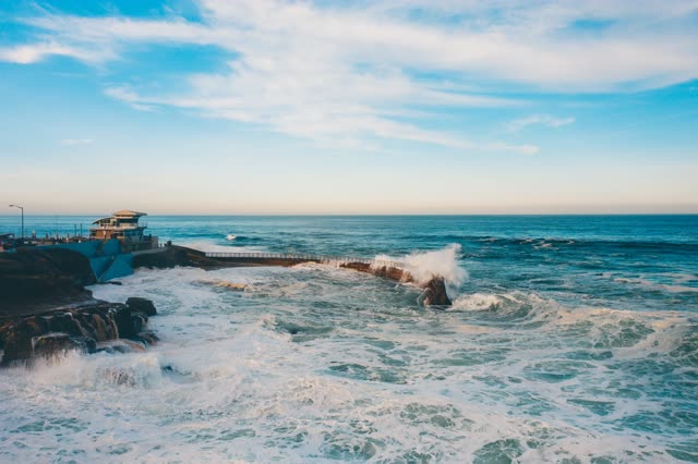 The cliffs, the surf and the ocean at La Jolla Cove.