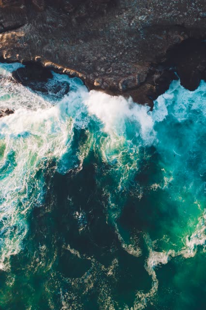 Aerial view of the cliffs, the surf and the ocean at La Jolla Cove.
