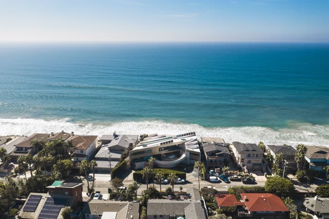 Aerial view of a residential street, the surf and palm trees in Encinitas.