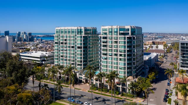 Low aerial view of the downtown streets, the skyline and palm trees at Bankers Hill.
