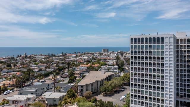 Aerial view of a residential street, palm trees and the ocean at La Jolla Country Club.