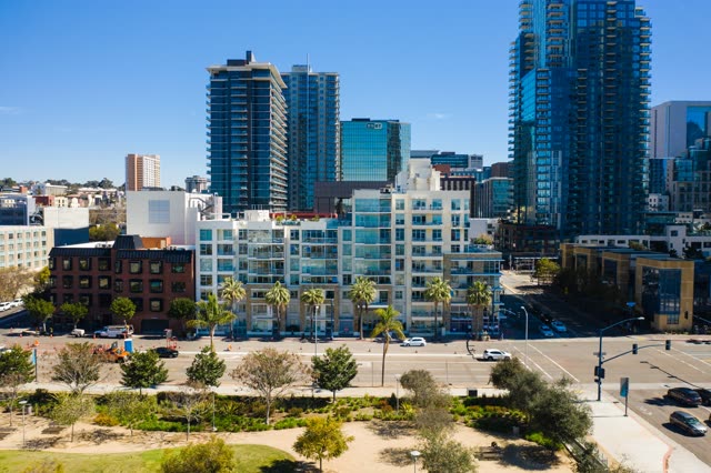 Low aerial view of the downtown streets, the skyline and palm trees at Waterfront.