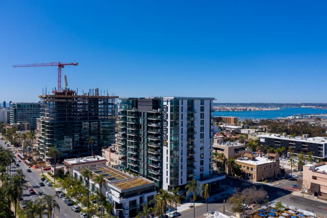 Aerial view of the downtown streets, palm trees and the bay at Bankers Hill, with a work crew on site.