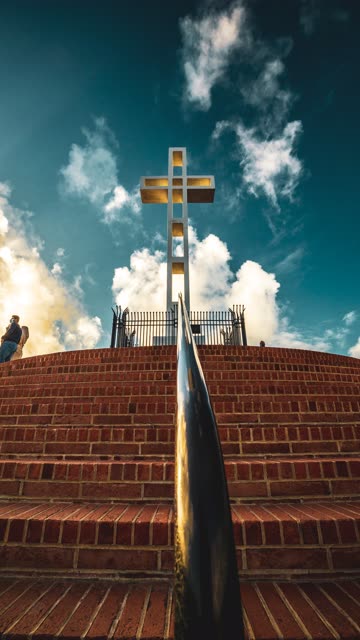 A park, the buildings and open country at Mount Soledad, with people walking.