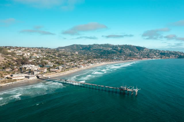 Aerial view of the beach, the surf and the pier at La Jolla Farms.