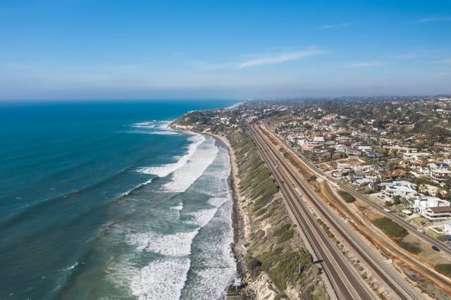 Aerial view of a residential street, the surf and the ocean in Cardiff.